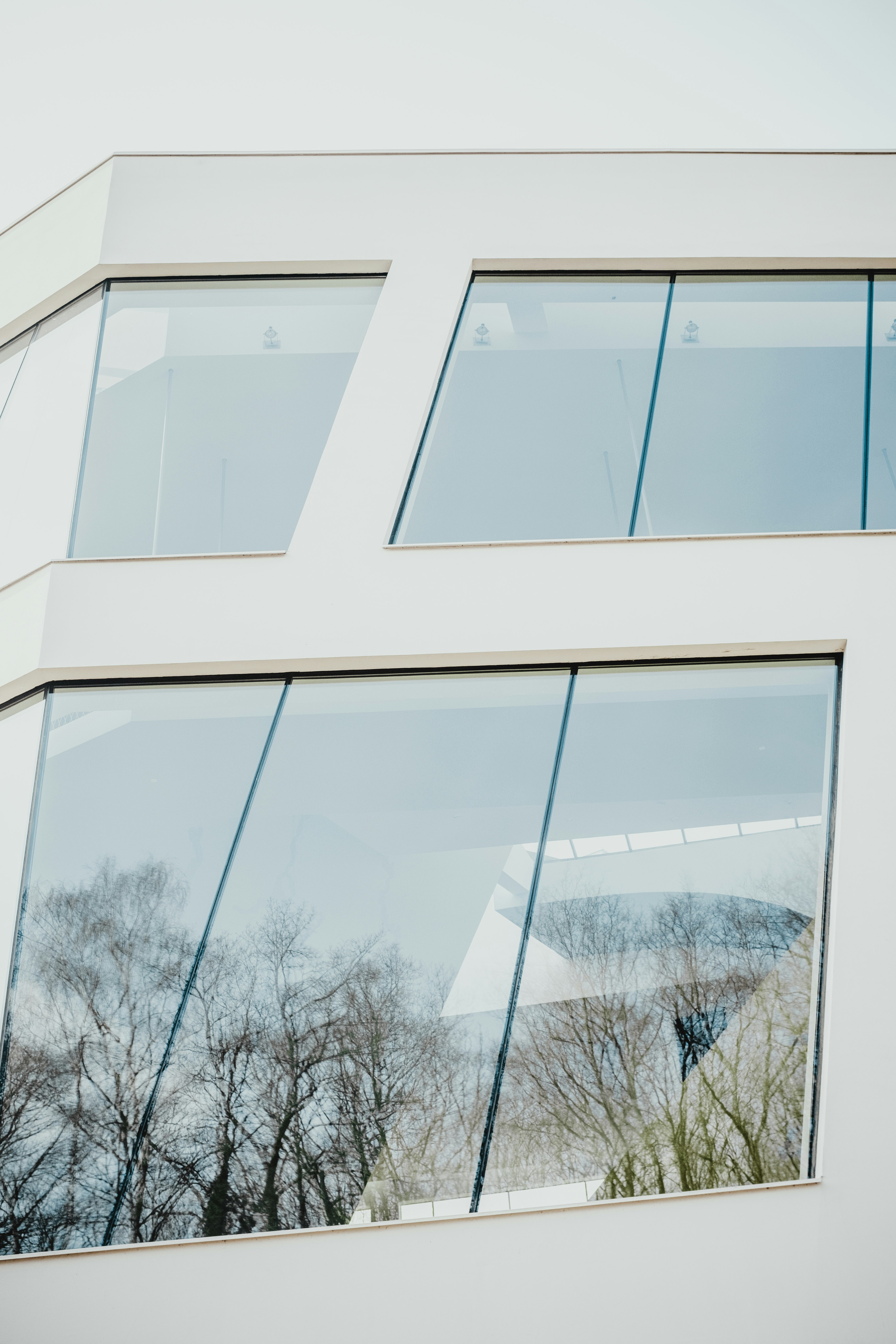 closed clear glass windows of white building